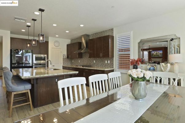 Dining room, Interior, Kitchen, Pendant Lights, Recessed Lighting, Stainless Steel Appliances, Wood Texture Flooring