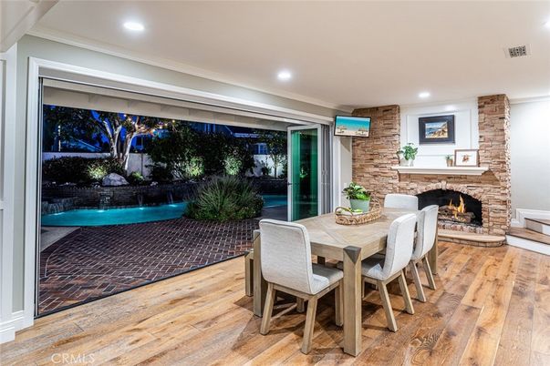 Dining room, Fireplace, Interior, Pool, Recessed Lighting, Stone Walls, Wood Texture Flooring