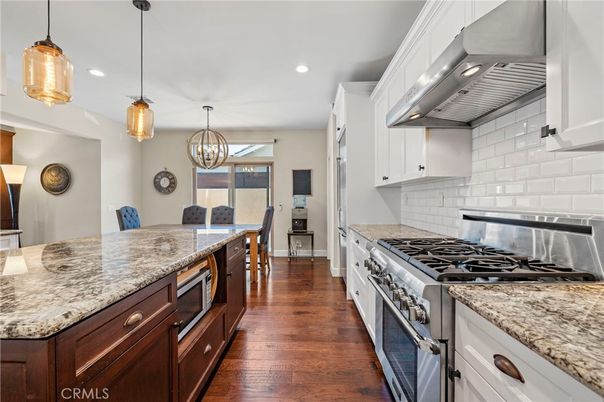 Chandelier, Dining room, Interior, Kitchen, Pendant Lights, Recessed Lighting, Stainless Steel Appliances, Wood Texture Flooring