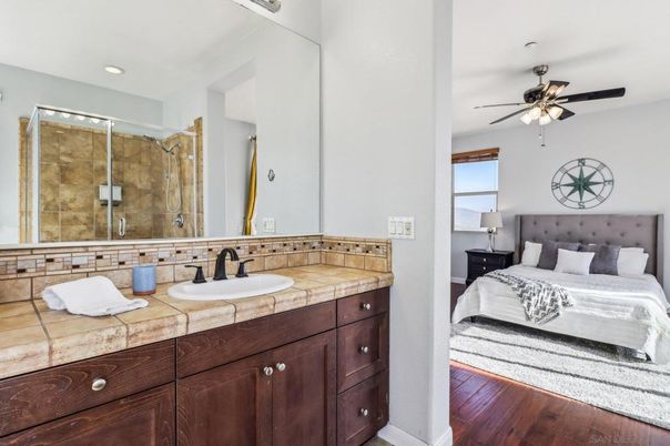 Bathroom, Bedroom, Glass Shower, Interior, Recessed Lighting, Tile Countertops, Wood Texture Flooring
