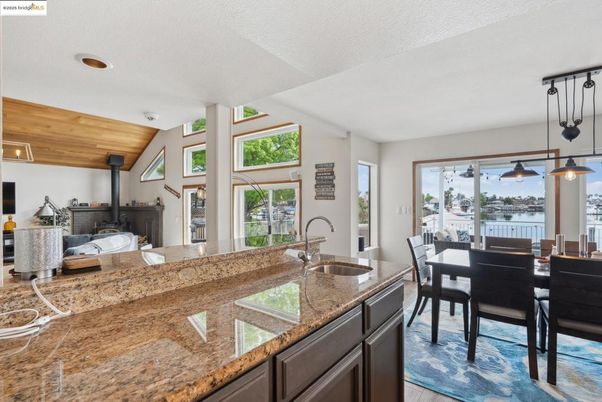 Dining room, Fireplace, Interior, Pendant Lights, Recessed Lighting, Water, Wooden Ceilings, Wood Texture Flooring