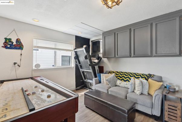 Fitness Equipment, Game Room, Interior, Living room, Recessed Lighting, Wood Texture Flooring