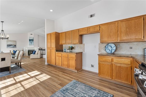 Chandelier, Dining room, Fireplace, Interior, Kitchen, Pendant Lights, Recessed Lighting, Wood Texture Flooring