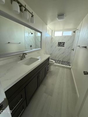 Bathroom, Dual Sink Vanities, Interior, Marble Walls, Wood Texture Flooring