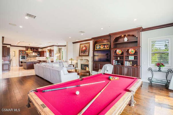 Billiard Table, Chandelier, Fireplace, Game Room, Interior, Kitchen, Living room, Pendant Lights, Recessed Lighting, Wood Texture Flooring