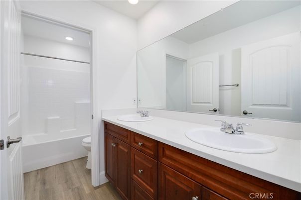 Bathroom, Dual Sink Vanities, Interior, Recessed Lighting, Wood Texture Flooring