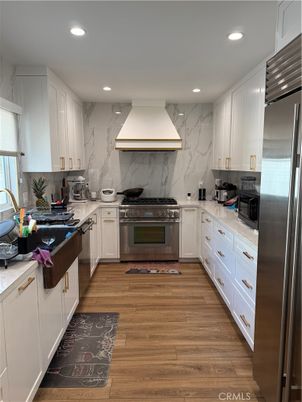 Interior, Kitchen, Marble Walls, Recessed Lighting, Stainless Steel Appliances, Wood Texture Flooring