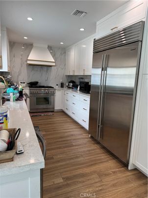 Interior, Kitchen, Marble Walls, Recessed Lighting, Stainless Steel Appliances, Wood Texture Flooring