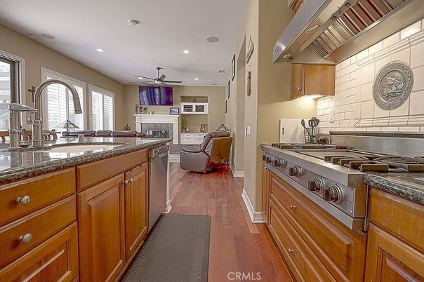 Fireplace, Interior, Kitchen, Living room, Recessed Lighting, Stainless Steel Appliances, Wood Texture Flooring