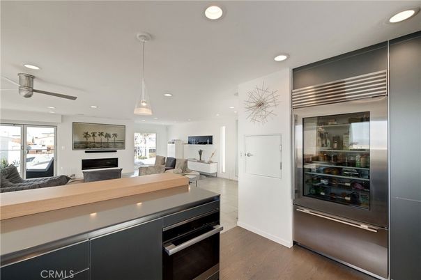 Fireplace, Interior, Kitchen, Living room, Pendant Lights, Recessed Lighting, Stainless Steel Appliances, Wood Texture Flooring