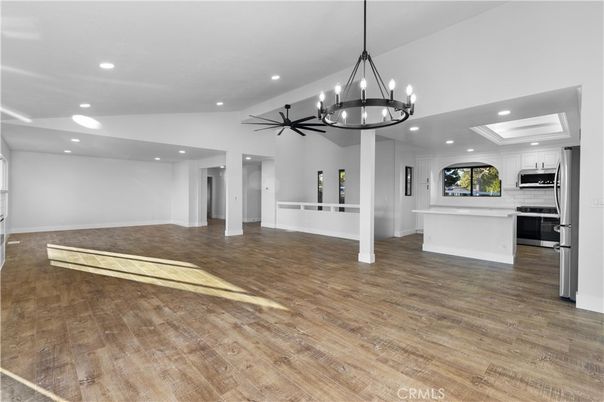 Chandelier, Empty room, Interior, Kitchen, Pendant Lights, Recessed Lighting, Stainless Steel Appliances, Wood Texture Flooring