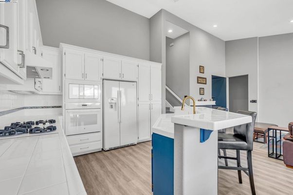 Interior, Kitchen, Recessed Lighting, Tile Countertops, Wood Texture Flooring