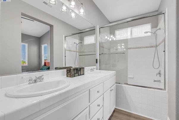 Bathroom, Dual Sink Vanities, Glass Shower, Interior, Tile Countertops, Wood Texture Flooring