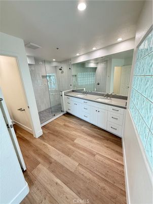 Bathroom, Dual Sink Vanities, Glass Shower, Interior, Recessed Lighting, Wood Texture Flooring
