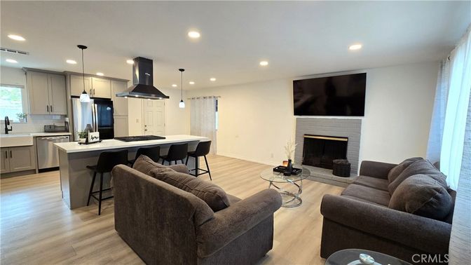 Fireplace, Interior, Kitchen, Living room, Pendant Lights, Recessed Lighting, Stainless Steel Appliances, Wood Texture Flooring
