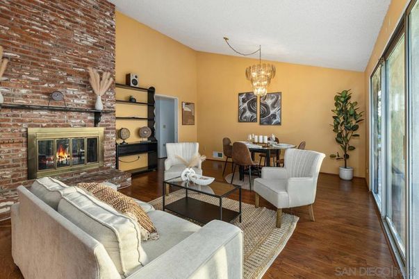 Chandelier, Dining room, Fireplace, Interior, Living room, Pendant Lights, Stone Walls, Wood Texture Flooring