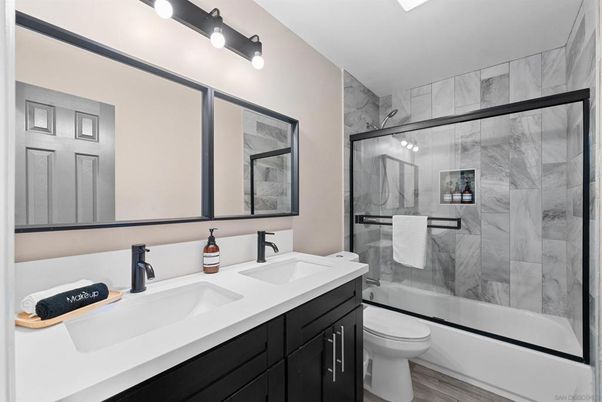 Bathroom, Dual Sink Vanities, Glass Shower, Interior, Marble Walls, Wood Texture Flooring