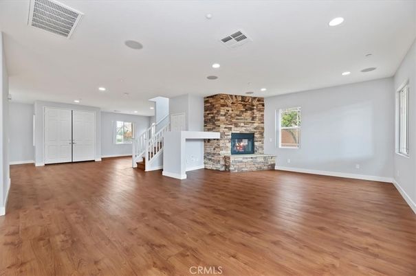 Empty room, Fireplace, Interior, Recessed Lighting, Stone Walls, Wood Texture Flooring