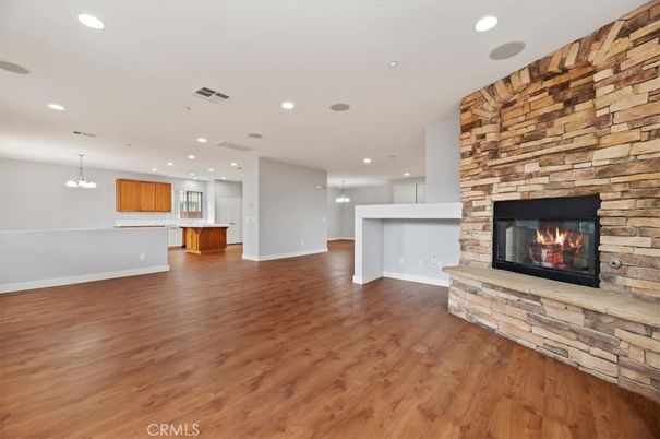 Empty room, Fireplace, Interior, Kitchen, Pendant Lights, Recessed Lighting, Stone Walls, Wood Texture Flooring