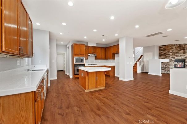 Interior, Kitchen, Recessed Lighting, Stainless Steel Appliances, Stone Walls, Tile Countertops, Wood Texture Flooring