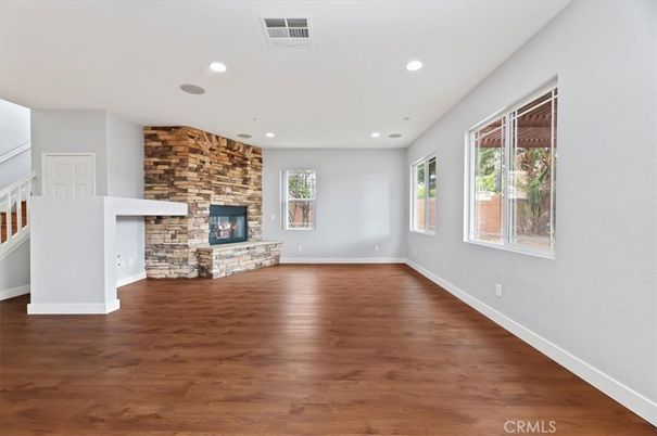 Empty room, Fireplace, Interior, Recessed Lighting, Stone Walls, Wood Texture Flooring