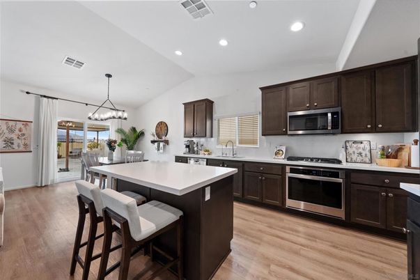 Dining room, Interior, Kitchen, Pendant Lights, Recessed Lighting, Stainless Steel Appliances, Wood Texture Flooring