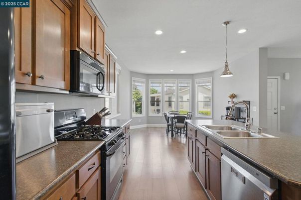 Dining room, Interior, Kitchen, Pendant Lights, Recessed Lighting, Stainless Steel Appliances, Wood Texture Flooring
