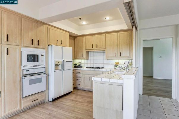 Interior, Kitchen, Recessed Lighting, Tile Countertops, Wood Texture Flooring
