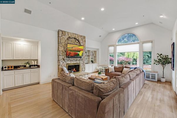 Fireplace, Interior, Living room, Recessed Lighting, Stone Walls, Wood Texture Flooring