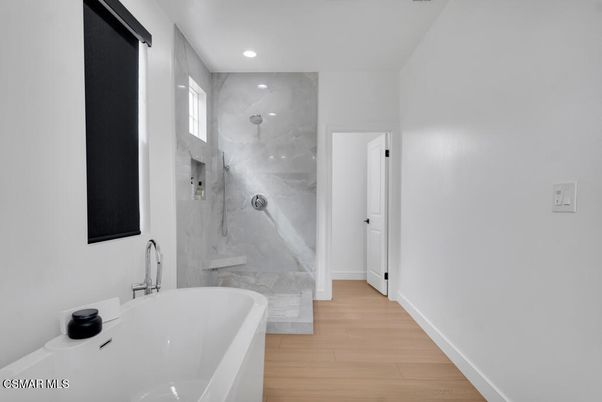 Bathroom, Free Standing Baths, Glass Shower, Interior, Marble Walls, Recessed Lighting, Wood Texture Flooring