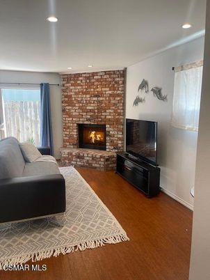 Fireplace, Interior, Living room, Recessed Lighting, Stone Walls, Wood Texture Flooring