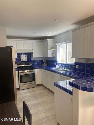 Interior, Kitchen, Recessed Lighting, Stainless Steel Appliances, Tile Countertops, Wood Texture Flooring