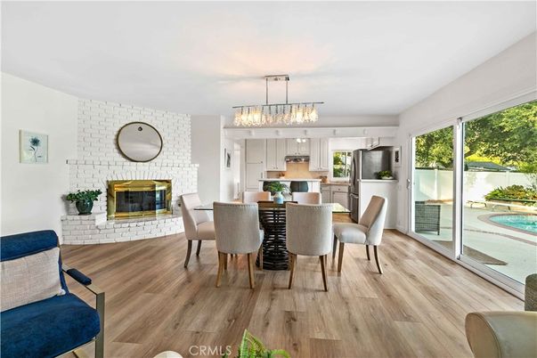 Chandelier, Dining room, Fireplace, Interior, Kitchen, Pendant Lights, Stainless Steel Appliances, Stone Walls, Wood Texture Flooring