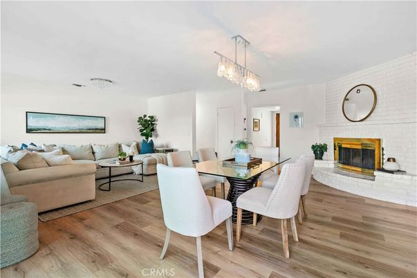 Chandelier, Dining room, Fireplace, Interior, Living room, Pendant Lights, Stone Walls, Wood Texture Flooring