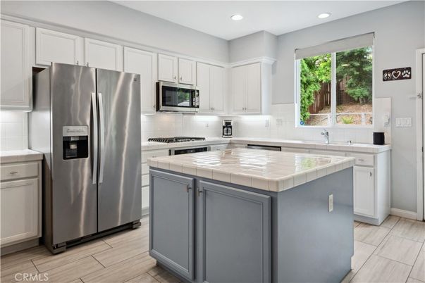 Interior, Kitchen, Recessed Lighting, Stainless Steel Appliances, Tile Countertops, Wood Texture Flooring