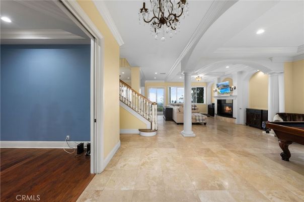 Chandelier, Fireplace, Interior, Living room, Piano, Recessed Lighting, Wood Texture Flooring