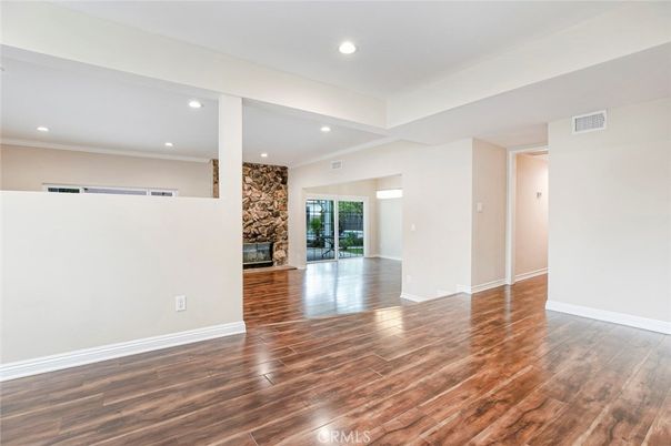 Empty room, Fireplace, Interior, Recessed Lighting, Stone Walls, Wood Texture Flooring