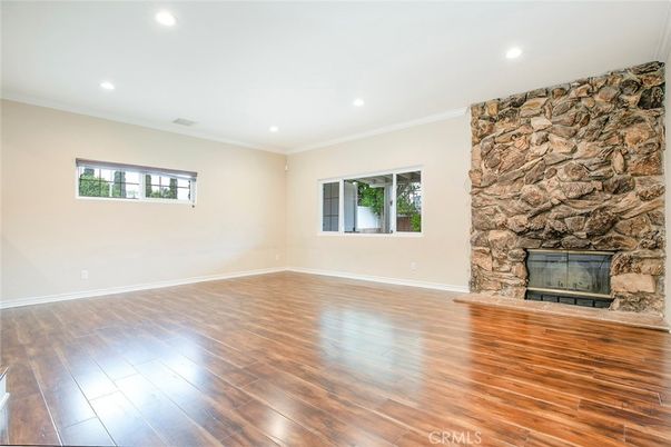 Empty room, Fireplace, Interior, Recessed Lighting, Stone Walls, Wood Texture Flooring