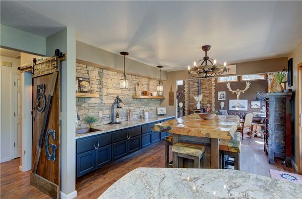 Chandelier, Dining room, Fireplace, Interior, Kitchen, Pendant Lights, Stone Walls, Wood Texture Flooring