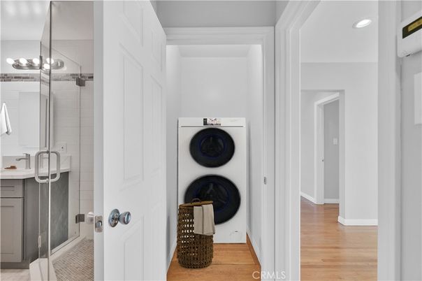 Bathroom, Glass Shower, Interior, Recessed Lighting, Washer, Wood Texture Flooring