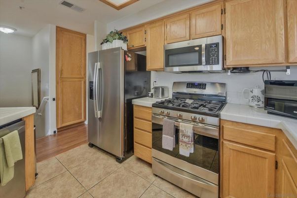 Interior, Kitchen, Stainless Steel Appliances, Tile Countertops, Wood Texture Flooring