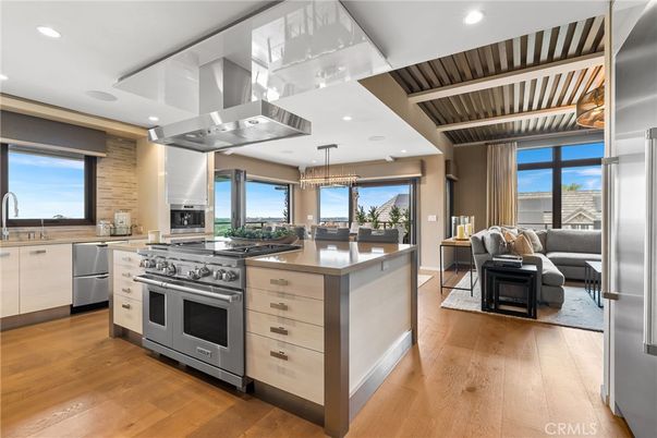 Chandelier, Dining room, Interior, Kitchen, Living room, Pendant Lights, Recessed Lighting, Stainless Steel Appliances, Wood Texture Flooring
