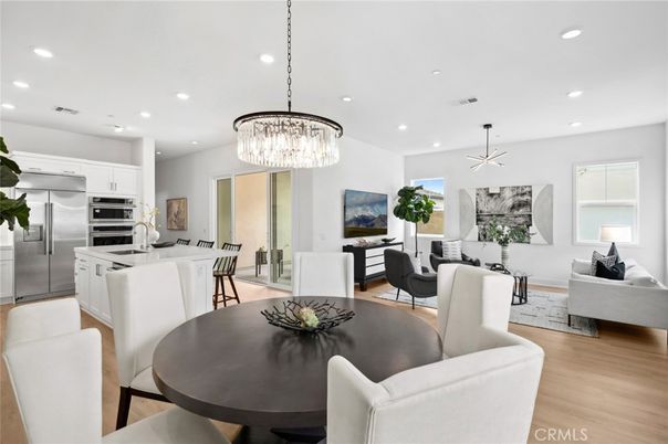 Chandelier, Dining room, Interior, Kitchen, Living room, Pendant Lights, Recessed Lighting, Stainless Steel Appliances, Wood Texture Flooring