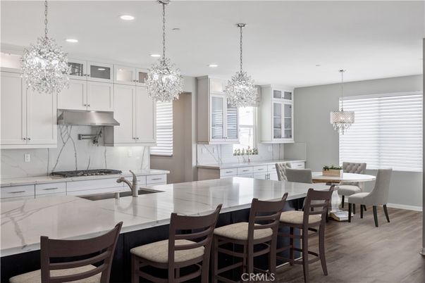 Chandelier, Dining room, Interior, Kitchen, Pendant Lights, Recessed Lighting, Stainless Steel Appliances, Wood Texture Flooring