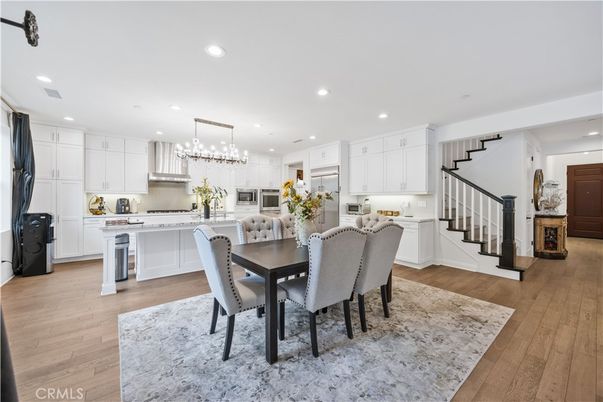 Chandelier, Dining room, Interior, Kitchen, Pendant Lights, Recessed Lighting, Stainless Steel Appliances, Wood Texture Flooring
