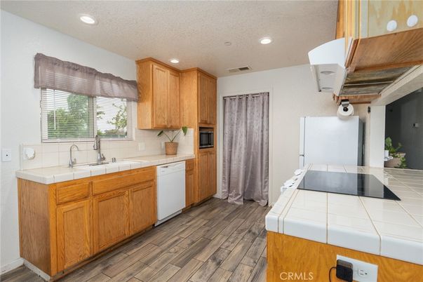 Interior, Kitchen, Recessed Lighting, Tile Countertops, Wood Texture Flooring