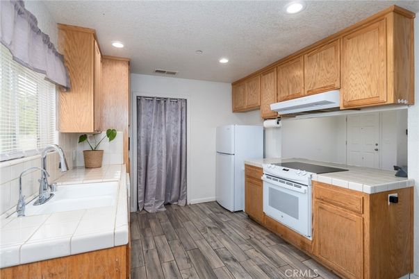 Interior, Kitchen, Recessed Lighting, Tile Countertops, Wood Texture Flooring