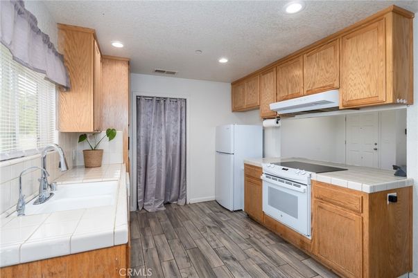 Interior, Kitchen, Recessed Lighting, Tile Countertops, Wood Texture Flooring