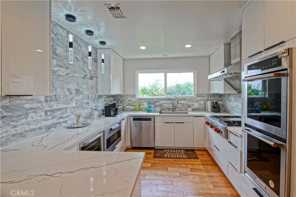 Interior, Kitchen, Marble Walls, Pendant Lights, Recessed Lighting, Stainless Steel Appliances, Wood Texture Flooring