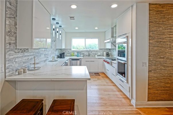 Interior, Kitchen, Marble Walls, Pendant Lights, Recessed Lighting, Stainless Steel Appliances, Wood Texture Flooring